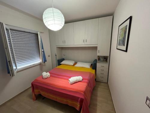 a small bedroom with a bed and a window at Il Cenerone in Pineto