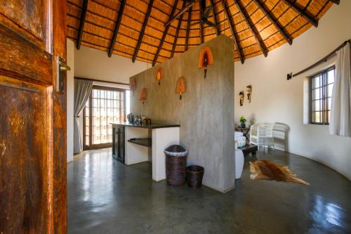 a large room with a kitchen and a living room at Mbizi Bush Lodge in Grietjie Game Reserve