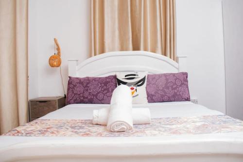 a bedroom with a bed with towels on it at Vista del mar homes in Malindi