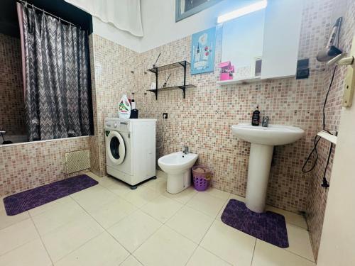 a bathroom with a sink and a washing machine at Le belvédère in Casablanca