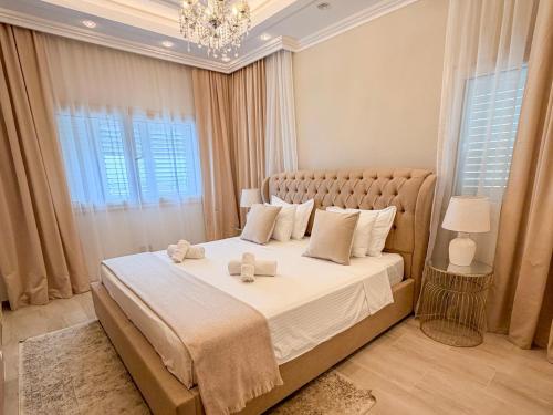 a bedroom with a large bed with two towels on it at Luxury Villa Aurelia in Peyia