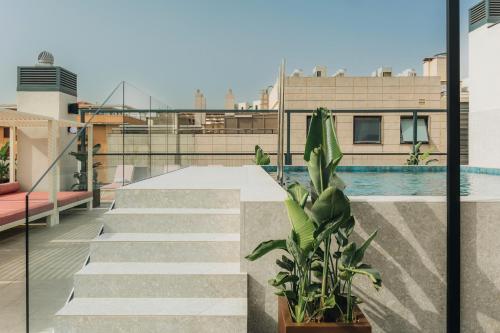 a balcony with stairs and a pool on a building at Ramirez Flats Valencia in Valencia