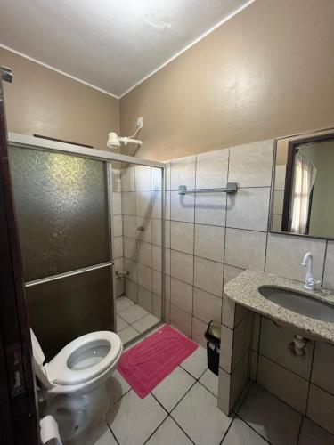 a bathroom with a shower and a toilet and a sink at Bela Vista in Canoa Quebrada