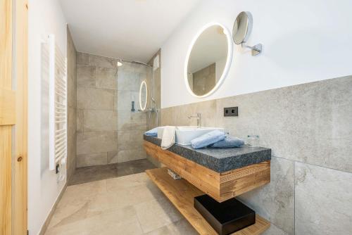 a bathroom with a sink and a mirror at Landhaus Lengg in Reit im Winkl