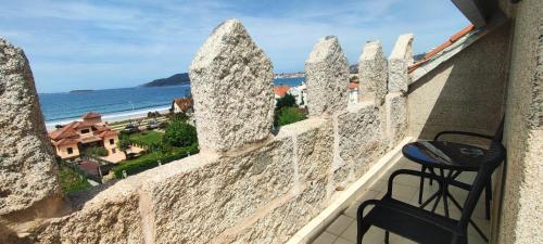 a balcony with a view of the ocean at Hotel Miramar Playa America Nigran in Nigrán