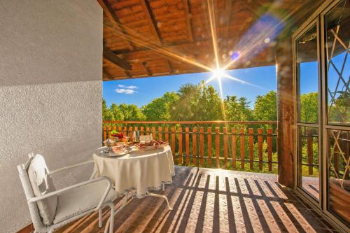 a table on the deck of a house at Villa La Verbanina Private Garden - Happy Rentals in Ghiffa
