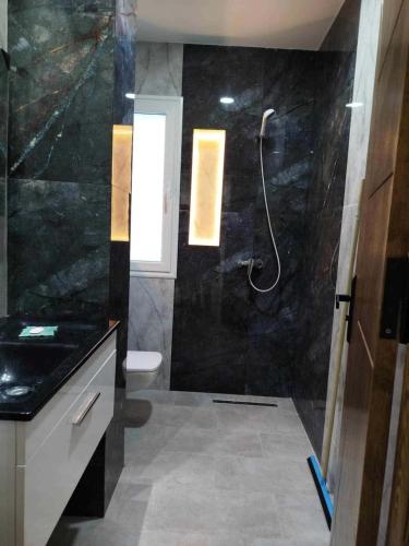 a bathroom with a shower and a toilet at Lemjid maison in Kelibia