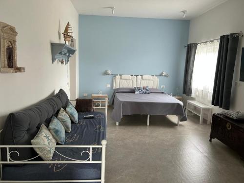 a living room with a bed and a couch at Tra Cielo e Mare - Monopoli in Impalata