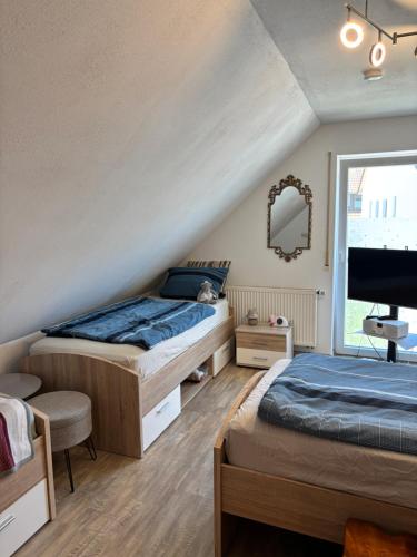 a bedroom with two beds and a flat screen tv at Luckylake in Muhr amSee