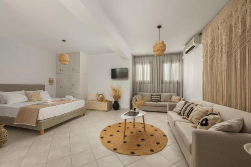 a living room with a bed and a couch at Villa Irina in Agios Prokopios