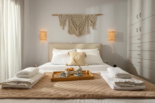 a bedroom with a bed with a tray on it at Villa Irina in Agios Prokopios
