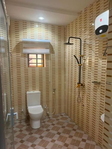 a bathroom with a toilet and a shower at ifetomitola in Iseri-Osun