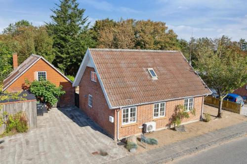 a red brick house with a brown roof at Villa With Three Bedrooms in Vemb