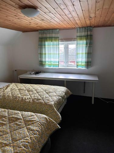 a bedroom with two beds and a window at Villa With Three Bedrooms in Vemb