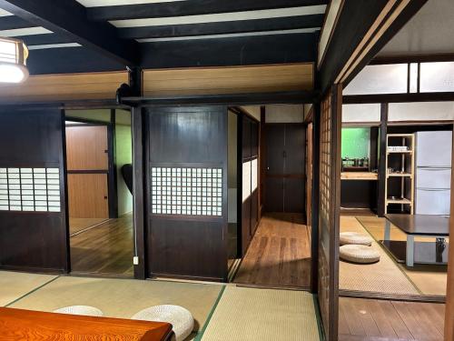 a room with wooden doors and a table at 川辺の時-Kawabe 川-山-BBQ in Hanno