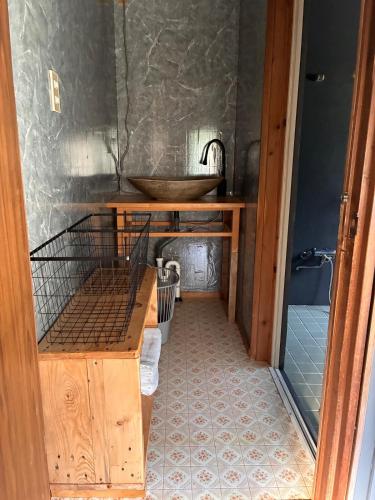 a bathroom with a sink and a wooden table at 川辺の時-Kawabe 川-山-BBQ in Hanno