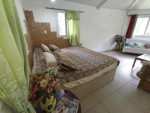 a bedroom with a large bed in a room at GranjaKatKery in Cerro Azul