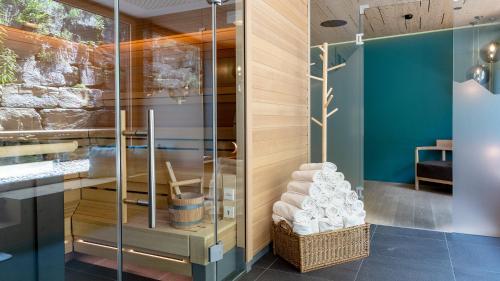 a glass shower stall with towels in a room at Bever Lodge in Bever
