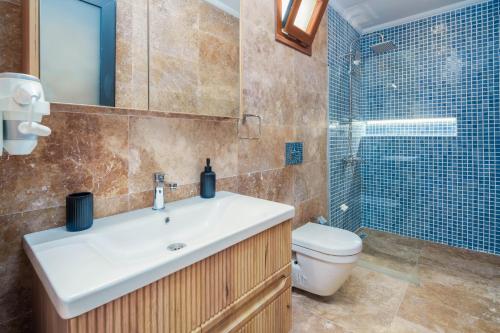 a bathroom with a sink and a toilet and a shower at Turquoise Retreat Spa & Wellness in Kaş