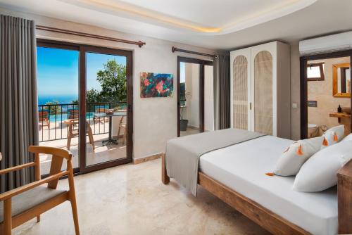 a bedroom with a bed and a view of the ocean at Turquoise Retreat Spa & Wellness in Kaş