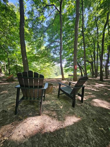 two benches and a picnic table in a park at The Hocking Hills Store Campsite #2 in Logan