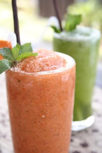 a close up of a drink with a green drink at Proud Phu Fah Maerim Resort in Mae Rim