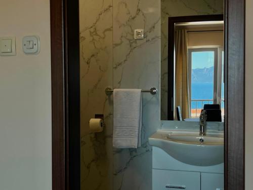 a bathroom with a sink and a mirror at Apartments Roncevic #JOKO# in Gradac