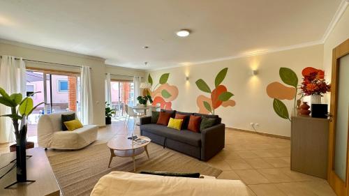a living room with a couch and a table at Santa Maria N - Shared Pool - 8 Guests - Albufeira in Albufeira