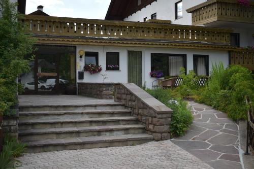 a house with a stone staircase in front of it at Sonnen Residence in Collalbo