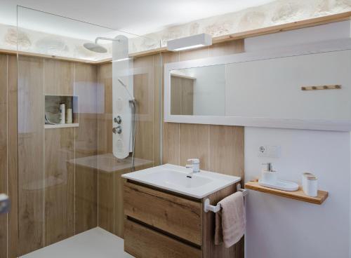 a bathroom with a sink and a shower at La cochera by Óscar Fuentes in Alcocer de Planes