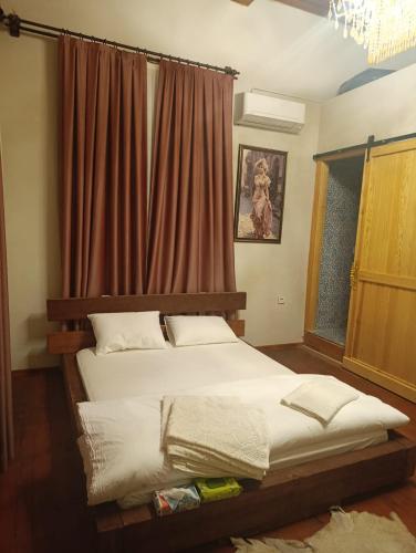 a bedroom with two beds in front of a window at Menekşe Sultan Köşkü Otel Oda 2 in Burunabat