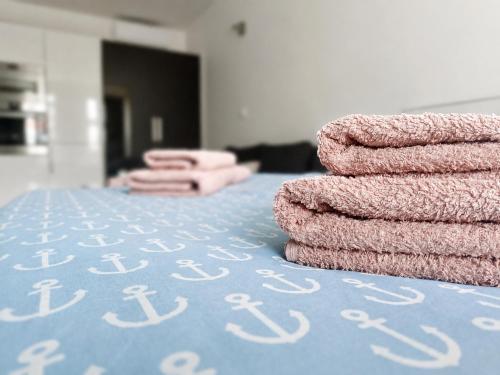 a pile of towels sitting on top of a table at RUMAKO apartments in Prague
