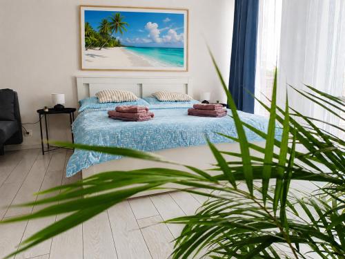 a bedroom with a bed with a view of the beach at RUMAKO apartments in Prague