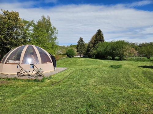 a tent with a bike parked in a field at Bulle insolite Wigwam in Aulnay-sur-Iton