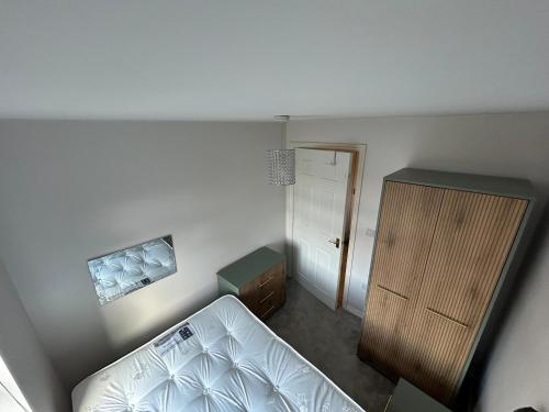 an overhead view of a bedroom with a bed and a cabinet at Light & Airy flat, Amazing view in Whitefield