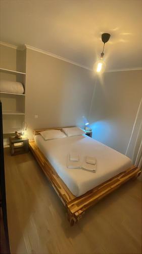 a bedroom with a large bed with a light on it at Ramboia Guest House in São Pedro do Sul