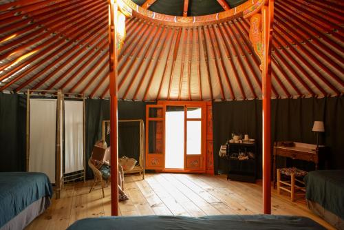 a room with a yurt with a wooden floor and a door at Yourte vue exceptionnelle in Teillet