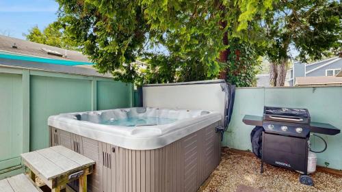a hot tub sitting next to a fence with a grill at Dewey Beach 102 Jersey St in Dewey Beach