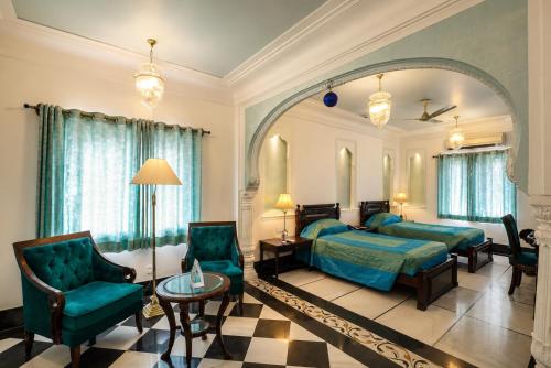 a bedroom with a bed and a large mirror at Shahpura House in Jaipur