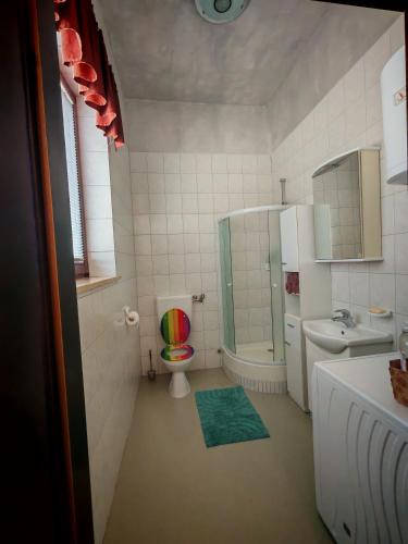 a bathroom with a toilet and a sink at WoW sleeping in Miklavž na Dravskem Polju