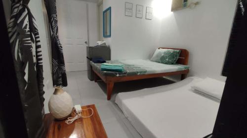 a small room with a couch and a bed at Anchor Doods in Romblon