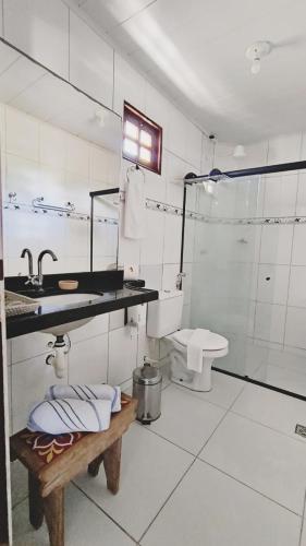 a white bathroom with a sink and a toilet at Pousada Recanto dos Milagres in São Miguel dos Milagres