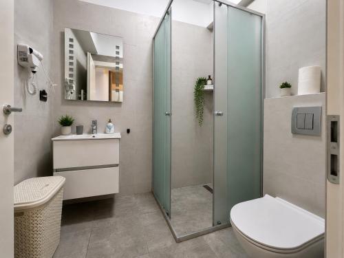 a bathroom with a shower with a toilet and a sink at Studio Sea On Beach in Mamaia
