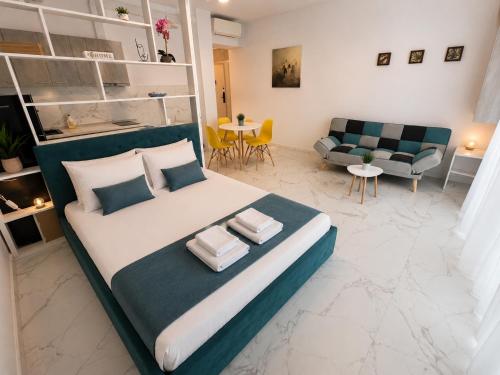 a bedroom with a large bed and a living room at Studio Sea On Beach in Mamaia