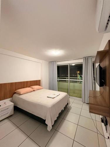 a bedroom with a bed and a large window at WestFlat - Barreto 206 in Mossoró