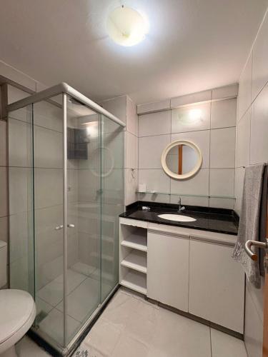 a bathroom with a glass shower and a sink at WestFlat - Barreto 206 in Mossoró
