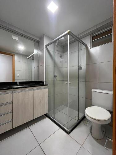 a bathroom with a glass shower and a toilet at WestFlat - BarretoStays 01 in Mossoró