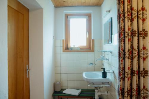 a bathroom with a sink and a window at Chalet Engihalde in Amden