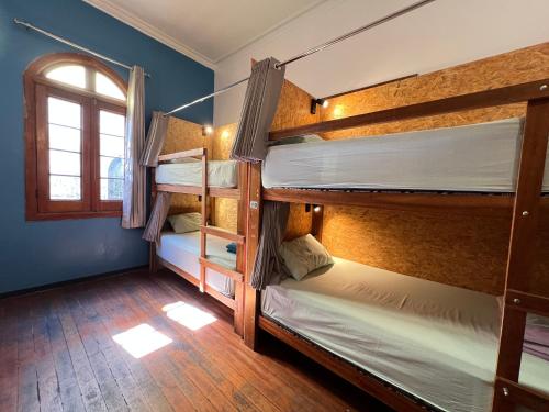 a room with four bunk beds with a window at Econunay Hostels in Arequipa