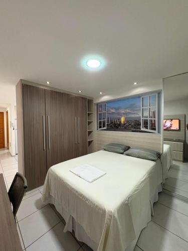 a bedroom with a large bed with a large window at West Flat - BarretoStays 03 in Mossoró
